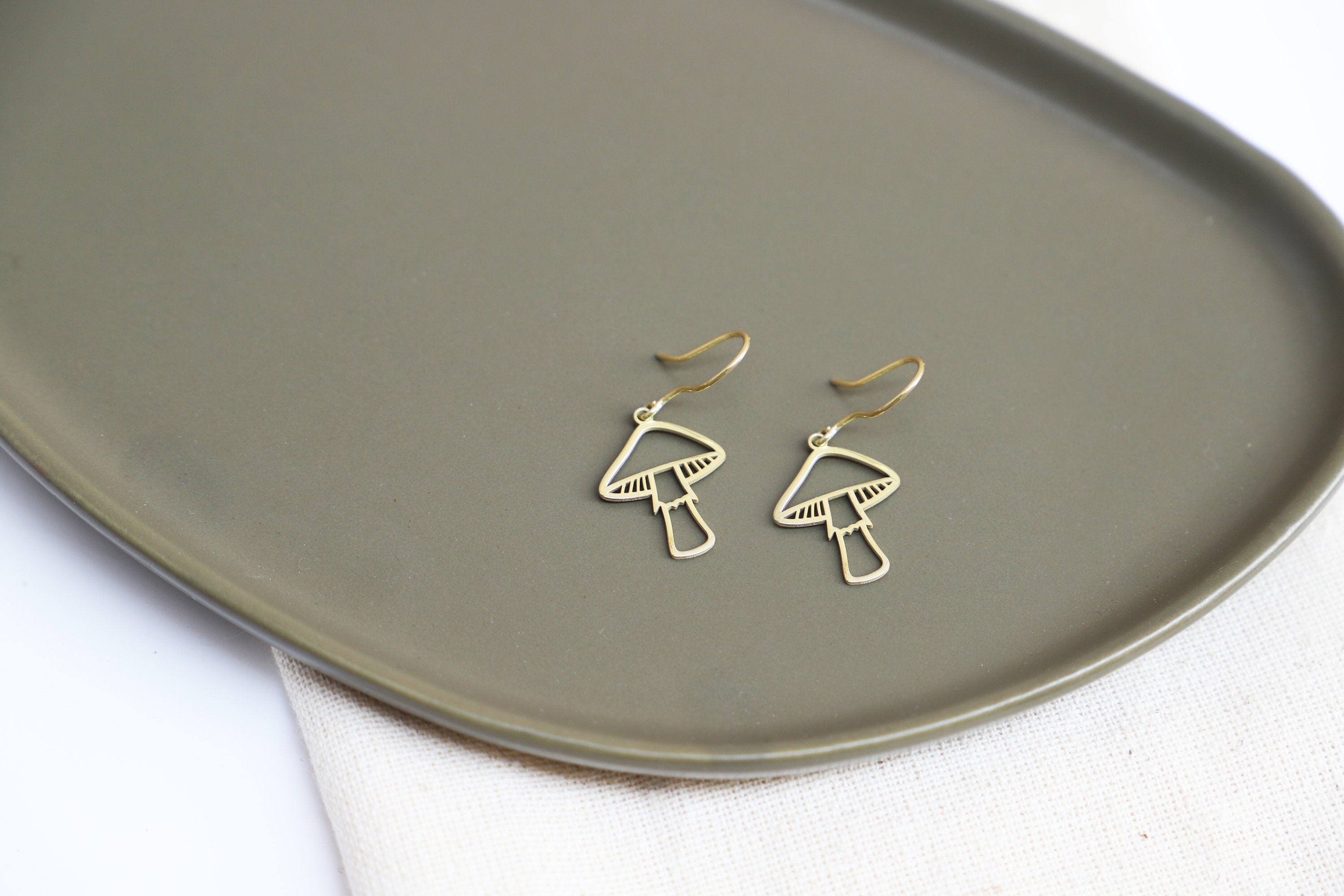 Gleaming Gold Dangle Earrings with Enchanting Mushroom Design