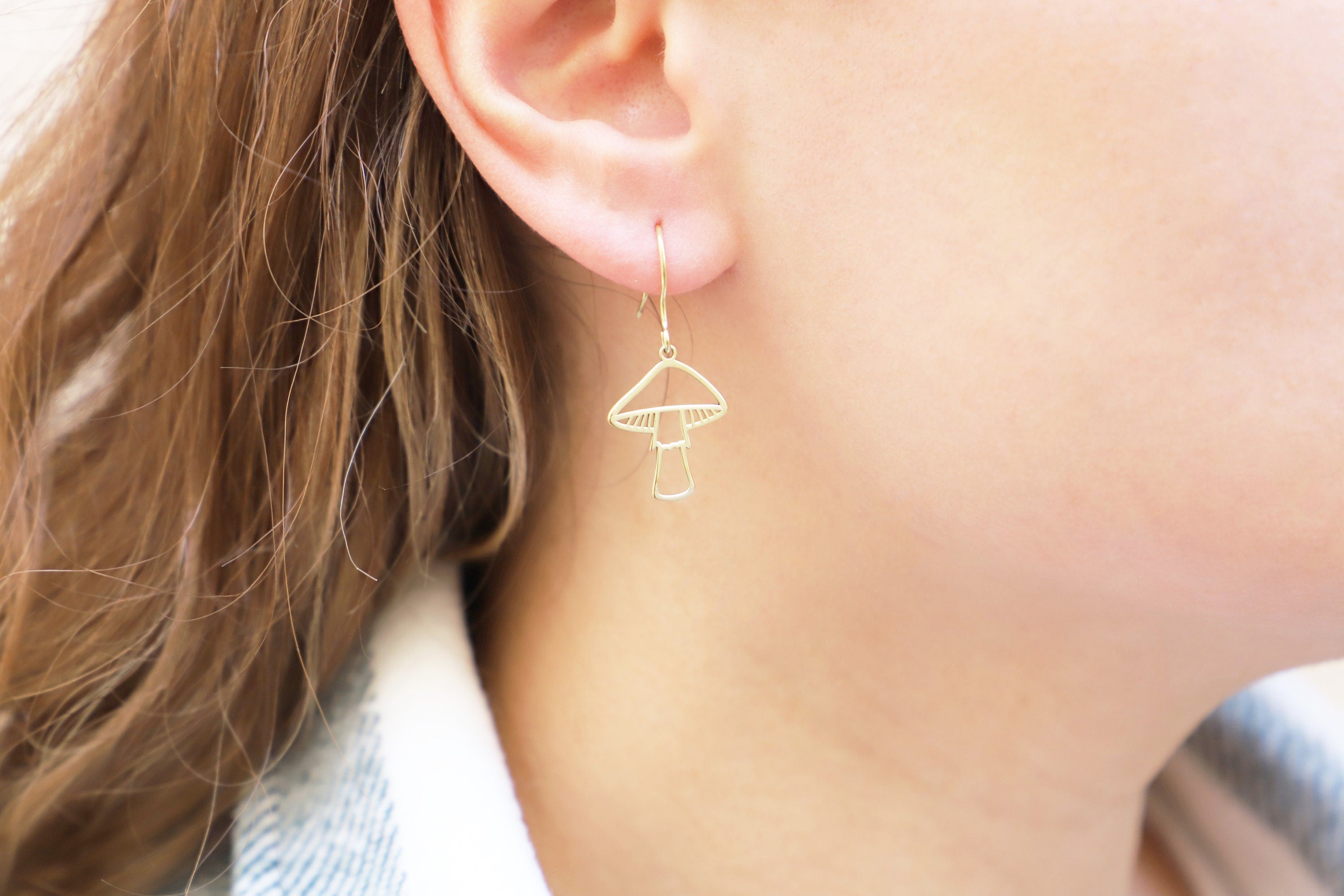 Gleaming Gold Dangle Earrings with Enchanting Mushroom Design